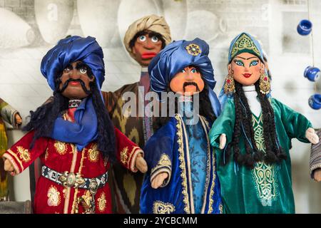 Handmade Uzbek hand puppets for sale are on the counter desk of tourist shop in old town of Bukhara, Uzbekistan Stock Photo