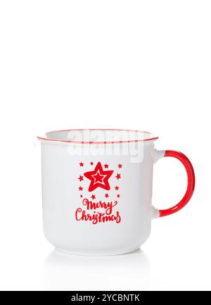 A white cup with a red handle and New Year inscriptions and patterns isolated on a white background. Stock Photo