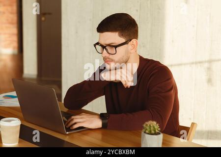 Office Manager Man Working On Laptop Computer Sitting At Workplace Stock Photo