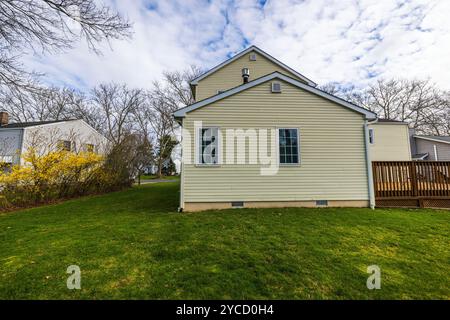 Side view of modern villa with green lawn and wooden deck in spring season. New Jersey. USA. Stock Photo