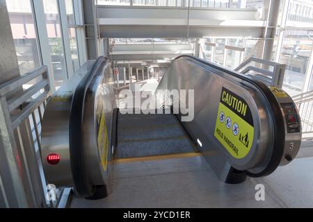 Caution Sign on Handrail of Escalator. Stock Photo