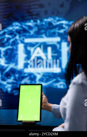Admin running AI cognitive computing tech on mockup tablet to simulate computerized model. Close up of green screen device used by IT specialist to do data mining with artificial intelligence Stock Photo