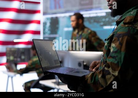 Military team manages cybersecurity operations in a high tech control ...