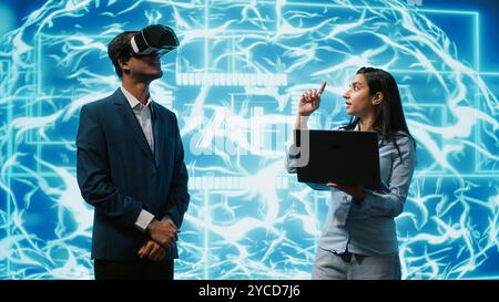 Engineers use VR smart goggles and AI neural networks to solve company problems. IT experts using artificial intelligence and AR virtual reality tech to visualize startup business data, camera A Stock Photo