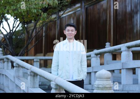 Chinese young man smile and looking at camera, front view Stock Photo