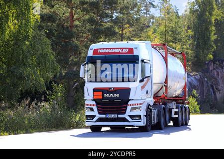 Customised white MAN truck of Tormanen.eu transports tank container along highway 52 on a sunny day of September. Salo, Finland. September 8, 2022. Stock Photo