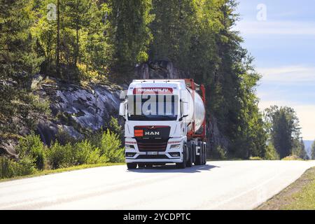 White MAN truck of Tormanen.eu transports tank container on highway 52 on a sunny day of September. Salo, Finland. September 8, 2022. Stock Photo