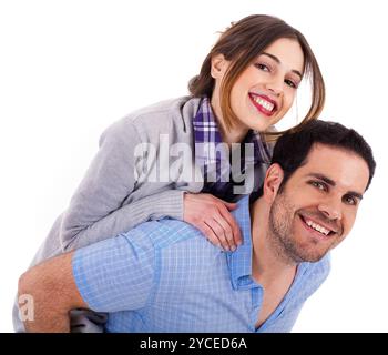 Young man carrying his girlfriend at the back on a white isolated background Stock Photo