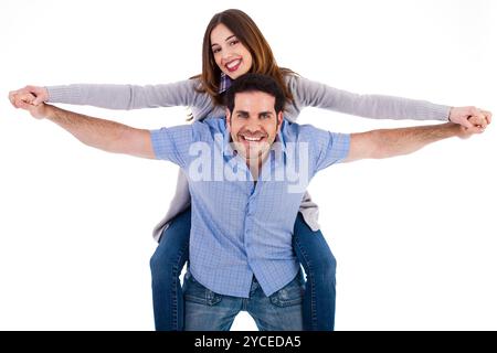 Front view of a couple in piggy back ride on a white isoalted background Stock Photo