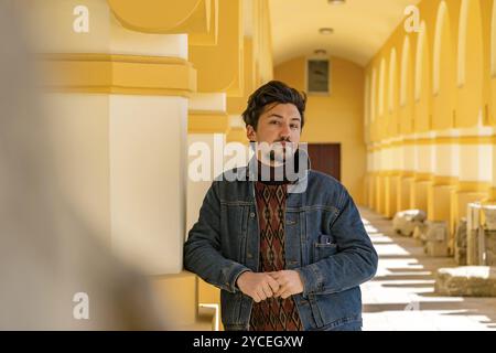 Portrait of a stylish handsome young man with a jaket outdoors. A serious man wearing a jaket looking confident at the camera Stock Photo