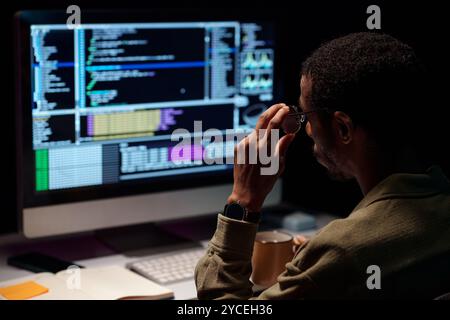 African American Developer Working Late at Night Stock Photo