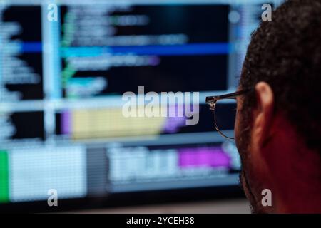 Analyzing Code on Computer Screen with Focused Mind Stock Photo