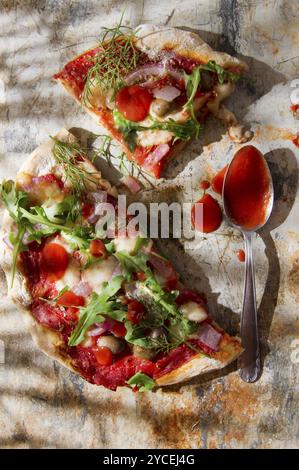 Pizza base with whole wheat flour with arugula and onion Stock Photo