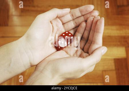 Female Hands holding two red Dice Stock Photo
