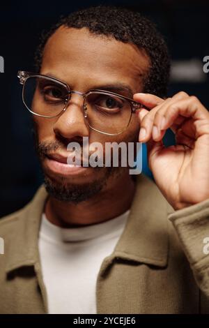 Portrait of African American Man Adjusting Glasses Stock Photo