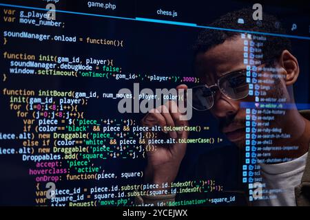 Focused Programmer Analyzing Code on Computer Screen Stock Photo