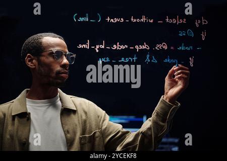 Writing Lines of Code on Transparent Board Stock Photo
