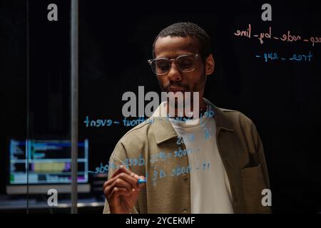 Analyzing Data on Transparent Glass Screen Stock Photo