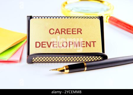 Business concept. The phrase, the text,the words CAREER DEVELOPMENT is written on a gold business card on a light background. Stock Photo