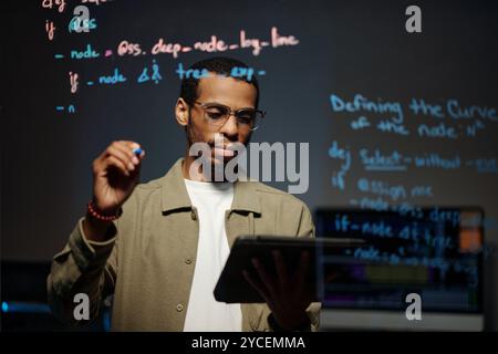Analyzing Code on Tablet for Software Development Stock Photo