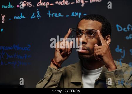 Contemplating Data Analysis During Coding Session Stock Photo