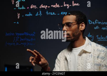 Writing Code on Transparent Screen for Developing Application Stock Photo