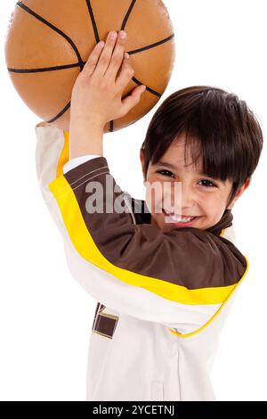 Little kid while throwing the ball while playing the basket ball  on white isolated background Stock Photo