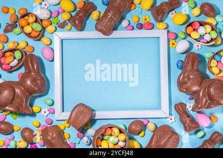 Easter chocolate egg and bunny background. High-colored flat lay with chocolate bunny and rabbits, colorful chocolate eggs. Preparation for Easter, gr Stock Photo