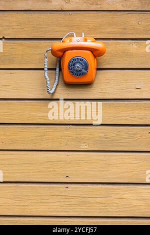 old telephone with dial on a wall Stock Photo