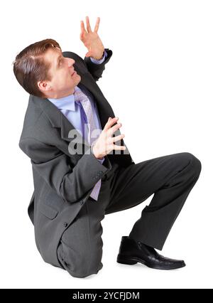 A young man scared and sat on a white background Stock Photo