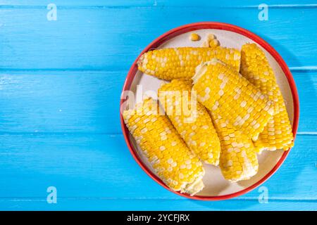 Sweet boiled corn cobs portions on plate, copy space Stock Photo