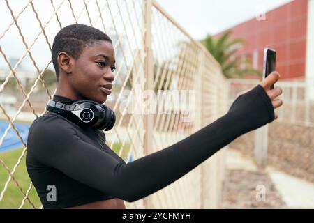 female with wireless headset taking selfie Stock Photo
