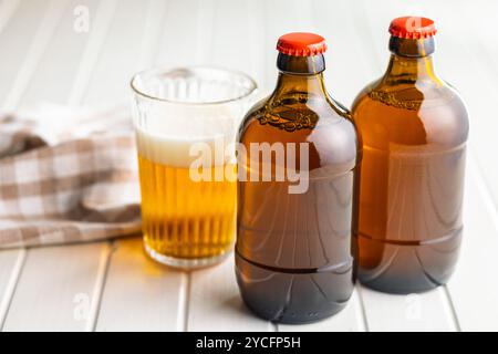 Two beer bottles on a white table. Stock Photo