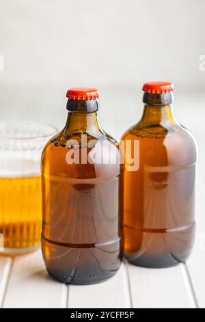 Two beer bottles on a white table. Stock Photo