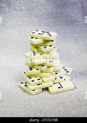 Old dominoes tower on canvas Stock Photo