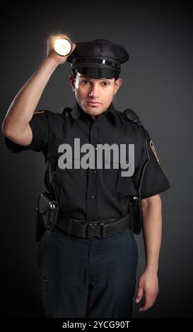 Policeman or Security Guard shining a torch Stock Photo