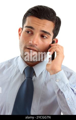 Serious salesman on his cellphone with colleague behind him against a ...