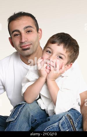 Father sitting with happy child Stock Photo