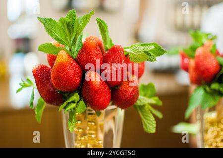 Freshly Gathered Strawberries with Mint in Elegant Arrangement. Stock Photo