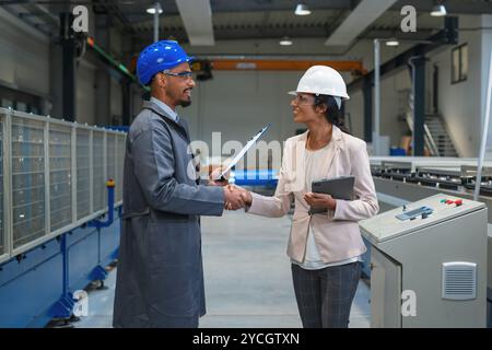 Two Professional Industry Engineers at Factory walking and Discussing production line Stock Photo