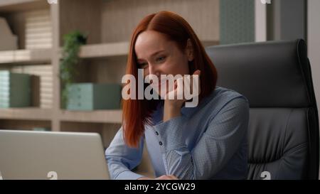 Happy satisfied busy Caucasian business woman at office workplace girl typing laptop working text to clients using pc online work project startup Stock Photo