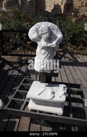 Damaged sculpture made of marble of a figure carrying a lamb on his shoulders apperantly Jesus found in Caesarea Stock Photo