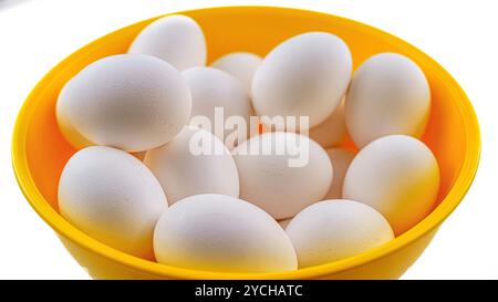 A group of chicken eggs on a yellow plastic container. Stock Photo