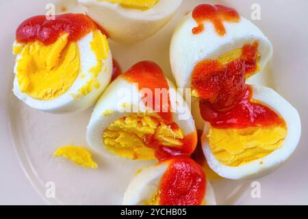 Boiled eggs with ketchup and salt. Stock Photo