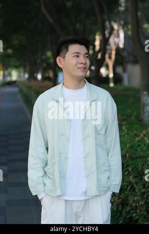 smiling Chinese young man outdoor Stock Photo