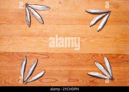 salted anchovies in group on wooden background Stock Photo