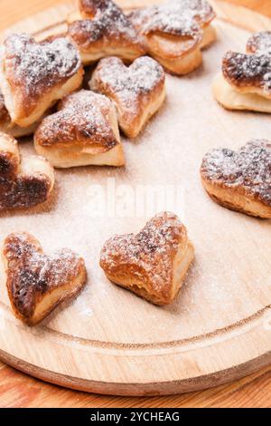 Bakery hearts from split pastry with sugar powder on wooden Stock Photo