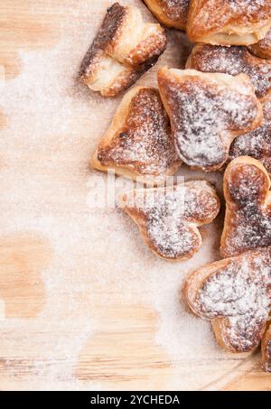 Bakery hearts from split pastry with sugar powder on wooden Stock Photo