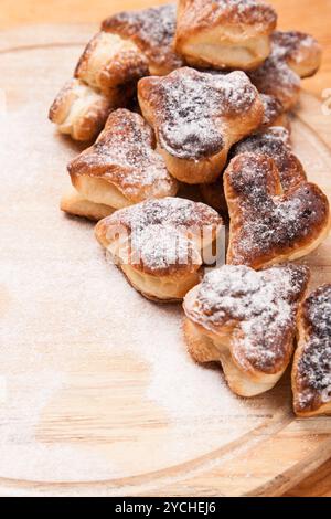 Bakery hearts from split pastry with sugar powder on wooden Stock Photo