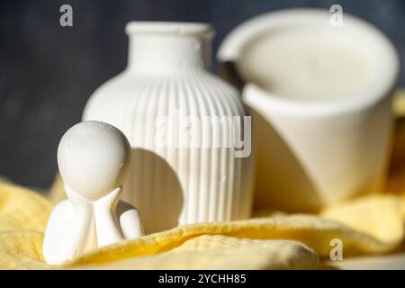 Homemade white ceramic candles on grey background. Stock Photo